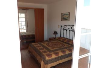 a bedroom with a bed in a room at Casa Angelus in Águilas