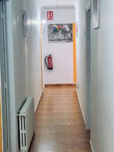 a hallway with a radiator and a painting on the wall at Mesón Kubano B&B in Sant Mateu