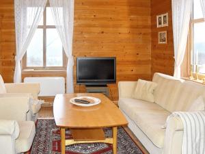 a living room with a couch and a tv at Holiday home vassenden in Vassenden