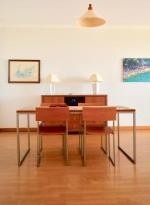 a dining room with a table and two chairs at Jardim do Arco "Esmee" in Arco da Calheta +38 photos