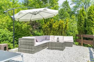 a patio furniture with an umbrella and a table at Nefryt - 600 m od PKP, duży parking, lodówka, czajnik, balkon, in Karpacz +45 photos