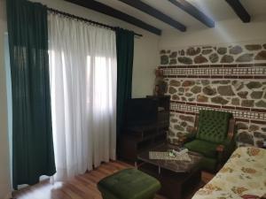 a living room with a green chair and a window at Villa Sofia in Ohrid