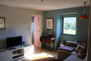 a living room with a couch and a window at Lugar da Lourida in Caminha