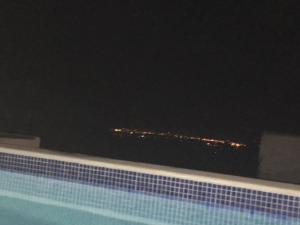 a view of a building at night from a swimming pool at CASA DO POÇO in Faro