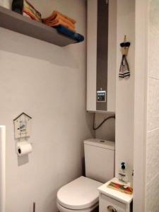 a small bathroom with a toilet and a cabinet at Charmant studio Bord de mer Plage Ste Marguerite Pornichet in Pornichet
