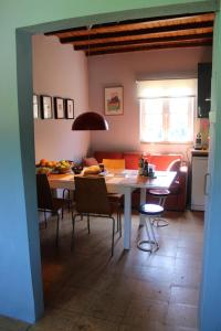 a kitchen and living room with a table and chairs at Lugar da Lourida in Caminha