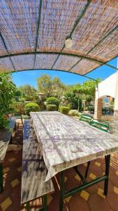 a large picnic table under an umbrella on a patio at Apartments Crljen in Brodarica