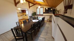 a dining room and kitchen with a table and chairs at Feher Cabana in Sovata