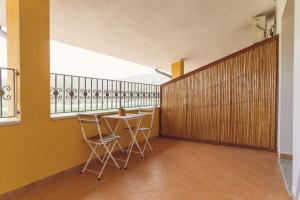 a room with a table and chairs and a balcony at Anima Hotel Sardinia in Fluminimaggiore