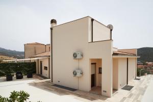 a white building with speakers on the side of it at Casa Chersonnesus in Teulada