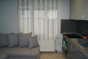 a living room with a couch in front of a window at City Room in Volos