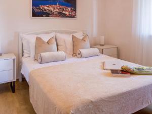 a white bed with pillows and a laptop on it at Apartment Karla in Korčula