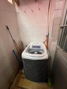 a small bathroom with a trash can in the corner at Casa Maragogi in Maragogi