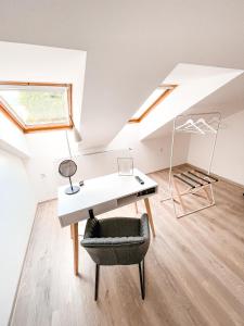 an attic office with a desk and a chair at Penzion Jakub in Lanškroun