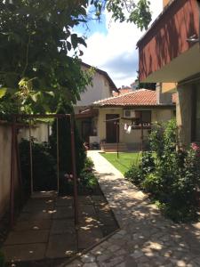 a garden with a gate and a house at Chervenkov Guest House in Chernomorets