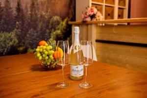 a bottle of champagne and two wine glasses on a table at Wellness Baška in Baška