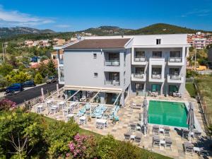 an aerial view of a building with a swimming pool at Patiras Deluxe B&B in Limenaria