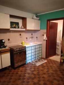 a kitchen with a stove and a counter top at CASA ELISA (casa della nonna) in Montereggio