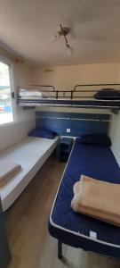 a room with three bunk beds and a window at Sunny Beach Mobile Homes Rosapineta in Rosapineta