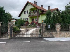 a house with a gate in front of it at Kanarek in Ustka