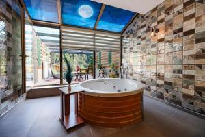 a large bathroom with a large tub in front of a window at Abant Aden Boutique Hotel & Spa in Abant