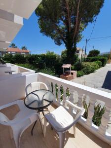 a patio with a table and chairs on a balcony at Rivulet Studios in Laganas