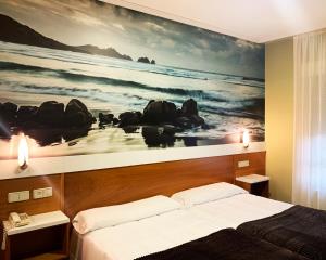 um quarto com uma grande pintura do oceano em Hotel Bello em O Pino 