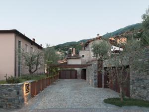 a stone walkway leading to a garage in a village at Casa Olea Hotel in Cremia