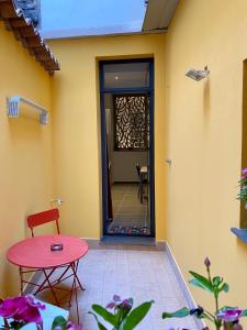 een patio met een rode tafel en een glazen deur bij Vecchia Ognina Apartments Catania - free Parking in Catania