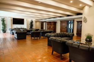 a conference room with leather chairs and a flat screen tv at Seehotel am Tankumsee in Isenbüttel