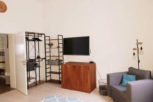 a living room with a flat screen tv on a wall at Apartment in Neudorf Nahe DU Zentrum und Uni/Zoo in Duisburg