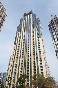 a tall building with a crane on top of it at Royal Club By RVHR, Noora Tower, Al Habtoor City, Business Bay in Dubai