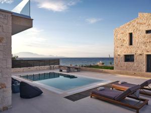 a swimming pool with a view of the ocean at LaLune SeaSide Villa, Zante Zen By ThinkVilla in Kipseli