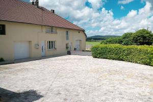 a house with a brick driveway in front of it at Les Moineaux Jura in Chavéria