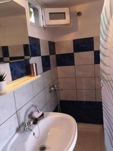 a bathroom with a sink and a mirror at Mandal Cottage in Samothraki +27 photos