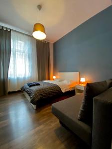 a bedroom with a bed and a couch at Ametyst Apartments in Krakow