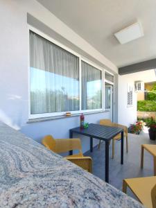a bedroom with a table and chairs and a window at The Nice Dreams Studio Apartment in Zadar