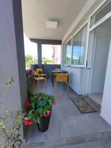 a patio with a table and chairs and plants at The Nice Dreams Studio Apartment in Zadar