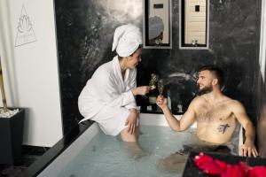 a woman standing in a bath tub with a man in the bath tub at INFINITY spa in Zrenjanin