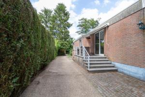 a brick building with stairs on the side of it at Vakantiehuis Salamander Maasmechelen in Maasmechelen