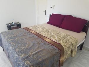 a bedroom with a bed with purple pillows on it at Golden Beach 1 for family in Ras Sedr +66 photos