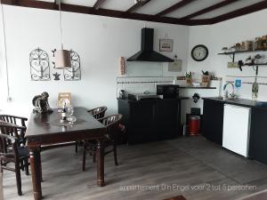 a kitchen and dining room with a table and chairs at D'n Engel in Sittard