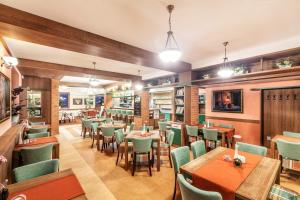 a restaurant with tables and chairs and books at Graphic Hotel in Nový Jičín