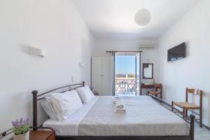 - une chambre avec un lit et un balcon dans l'établissement Villa Aegeo Studios, à Batsi