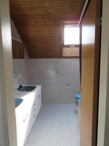 a bathroom with a sink and a toilet at good bed Niederbipp 13 in Niederbipp +7 photos
