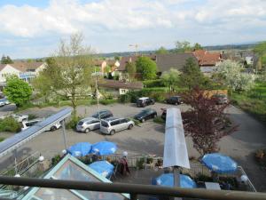 a view of a parking lot with cars and blue tarps at good bed Niederbipp 13 in Niederbipp