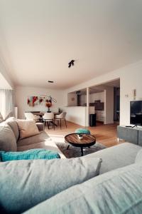 a living room with two couches and a table at Floride, The Perfect Getaway in Koksijde