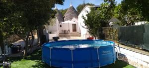 a hot tub in the yard of a house at Trulli di nonno Ciccio in Cisternino