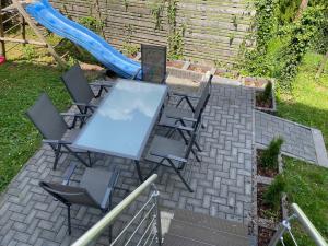 a table and chairs with a slide in a backyard at Ferienwohnungen AKH Home in Sankt Wendel