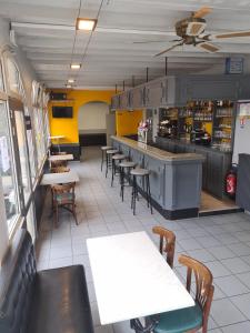 a restaurant with tables and chairs and a counter at LE CHAPON BRESSAN in Branges